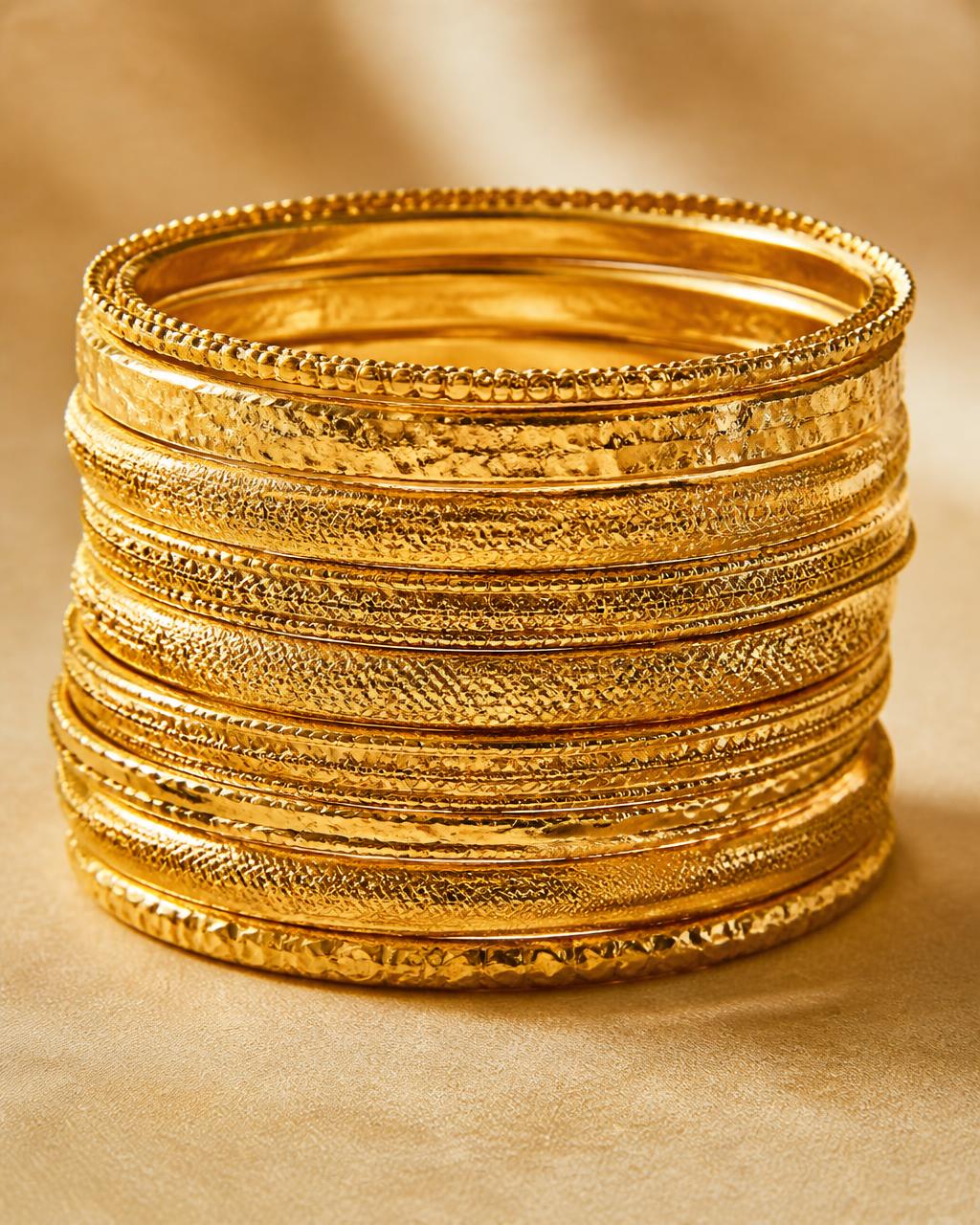 Stack of textured gold bangles