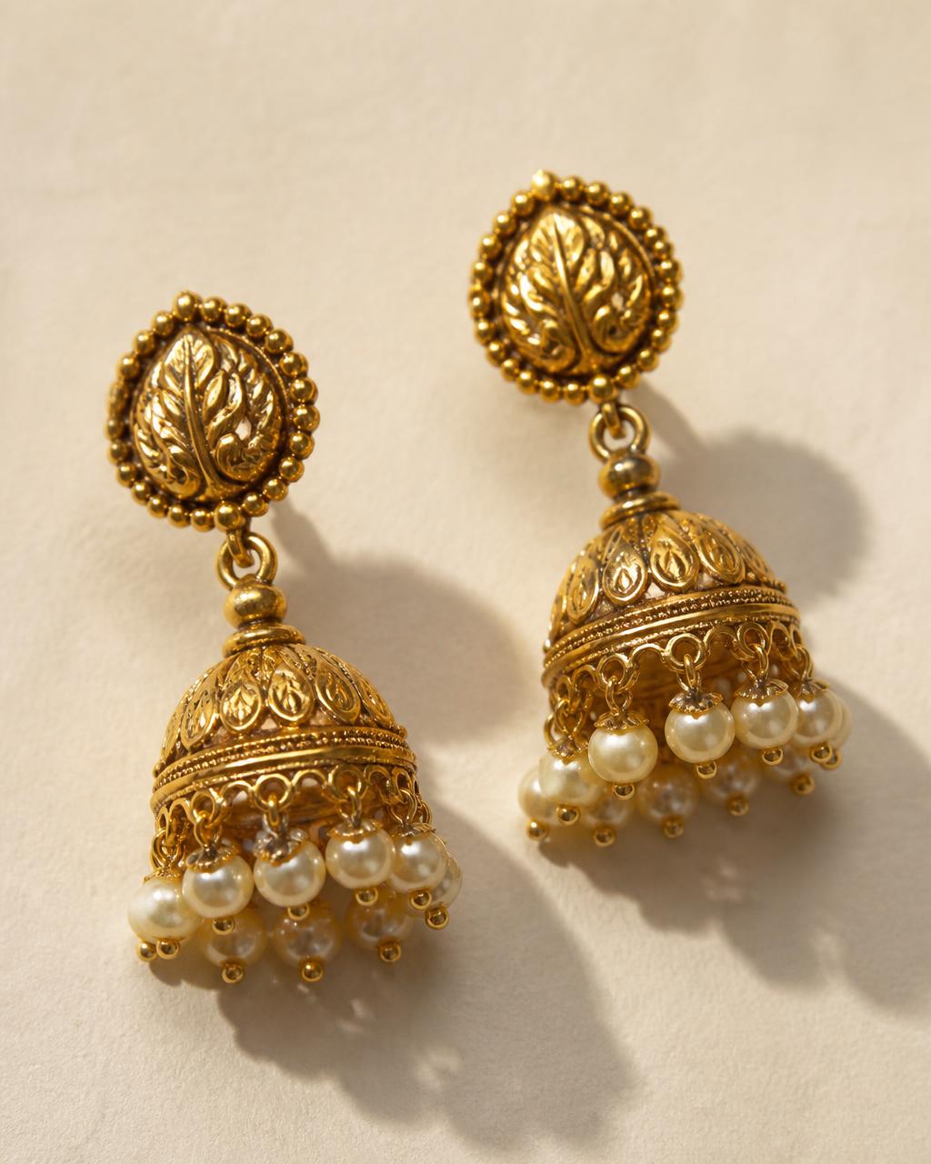 Gold jhumka earrings with pearl drops